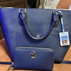 Michael Kors. Navy Blue leather with matching wallet.